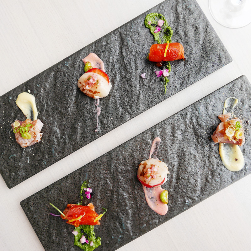 Aburi Sashimi: trio selection of flame seared salmon, scallop and tuna with signature sauces.