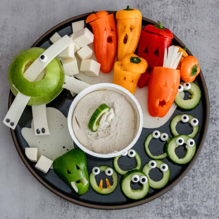 How To Make A Killer Vegetarian Halloween Grazing Board with fresh vegetables, plant-based cheeses, fresh fruits and homemade dips.